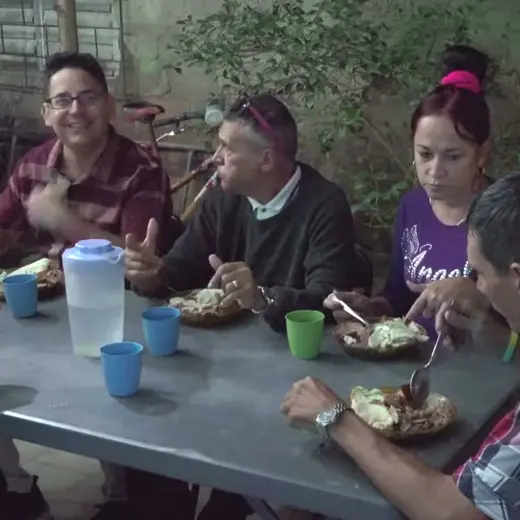 Friends in Cuba sharing a meal around a table